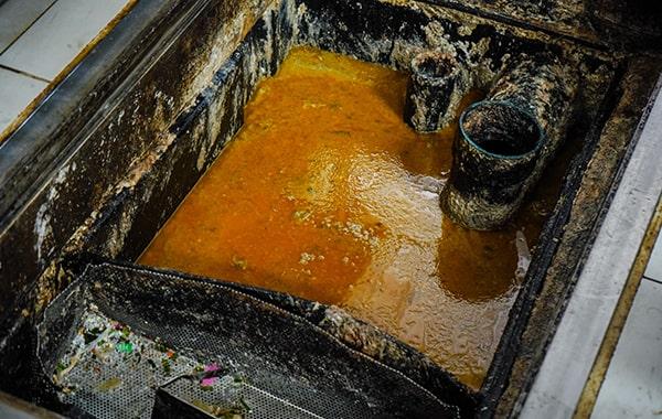 putting off grease trap cleaning can lead to clogs, foul odors, and even sewage backups